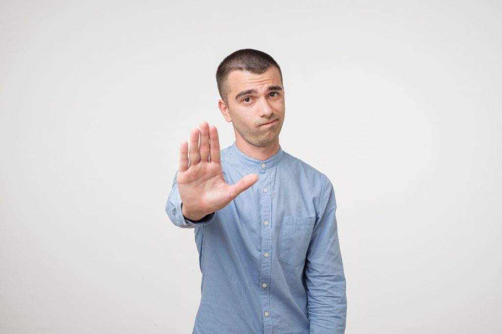 man showing stop gesture for food